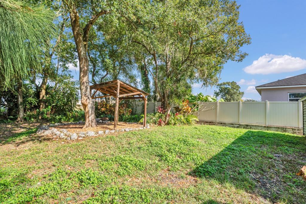 5357 Sunrise Boulevard Orlando, FL 32803 - Photo 22 of 26 a backyard of a house with table and chairs