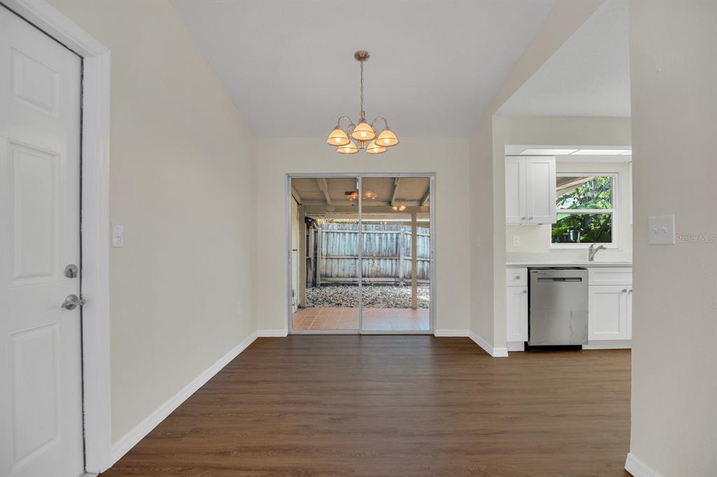 5357 Sunrise Boulevard Orlando, FL 32803 - Photo 5 of 26 wooden floor in an empty room with a window