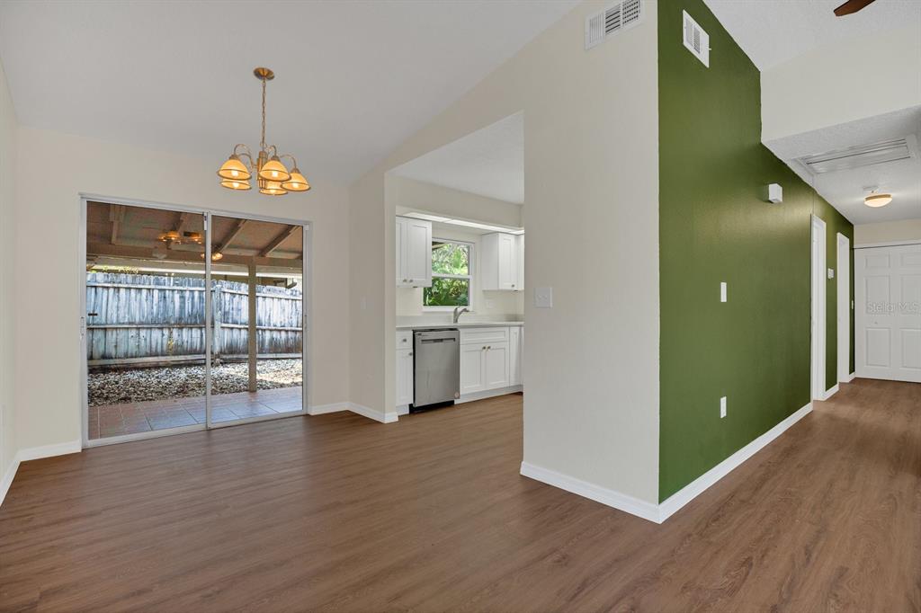 5357 Sunrise Boulevard Orlando, FL 32803 - Photo 6 of 26 a view of a room with wooden floor cabinet and stairs