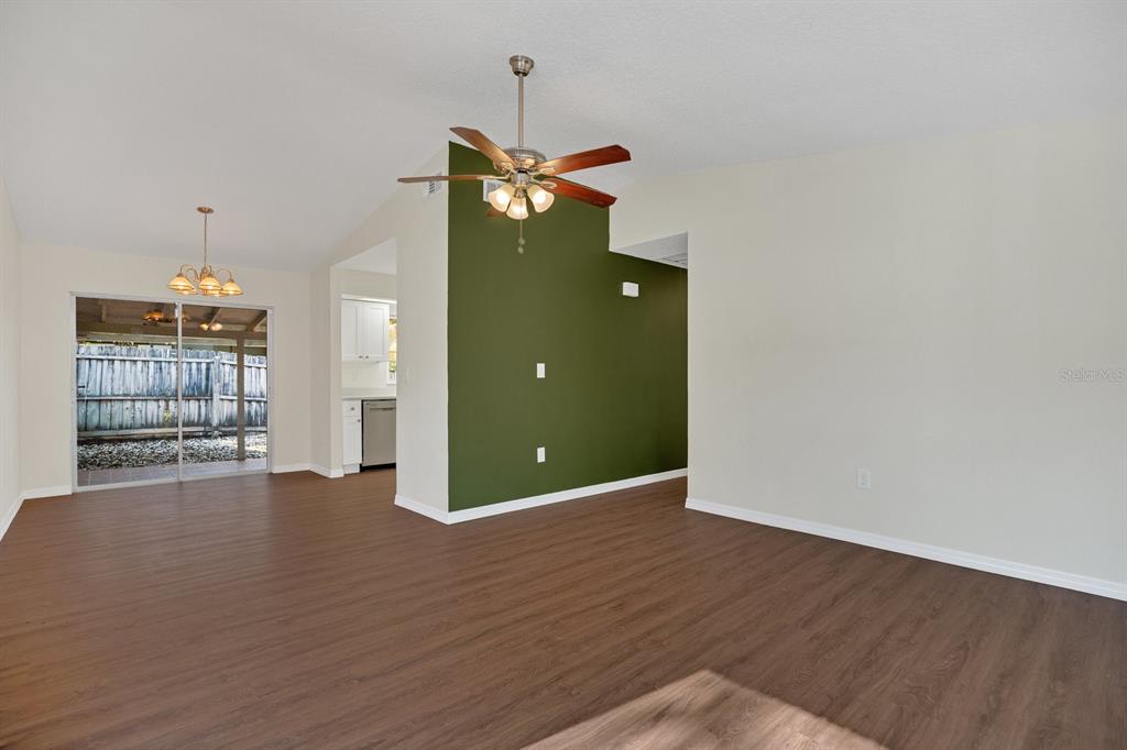5357 Sunrise Boulevard Orlando, FL 32803 - Photo 7 of 26 a view of an empty room with wooden floor and a window