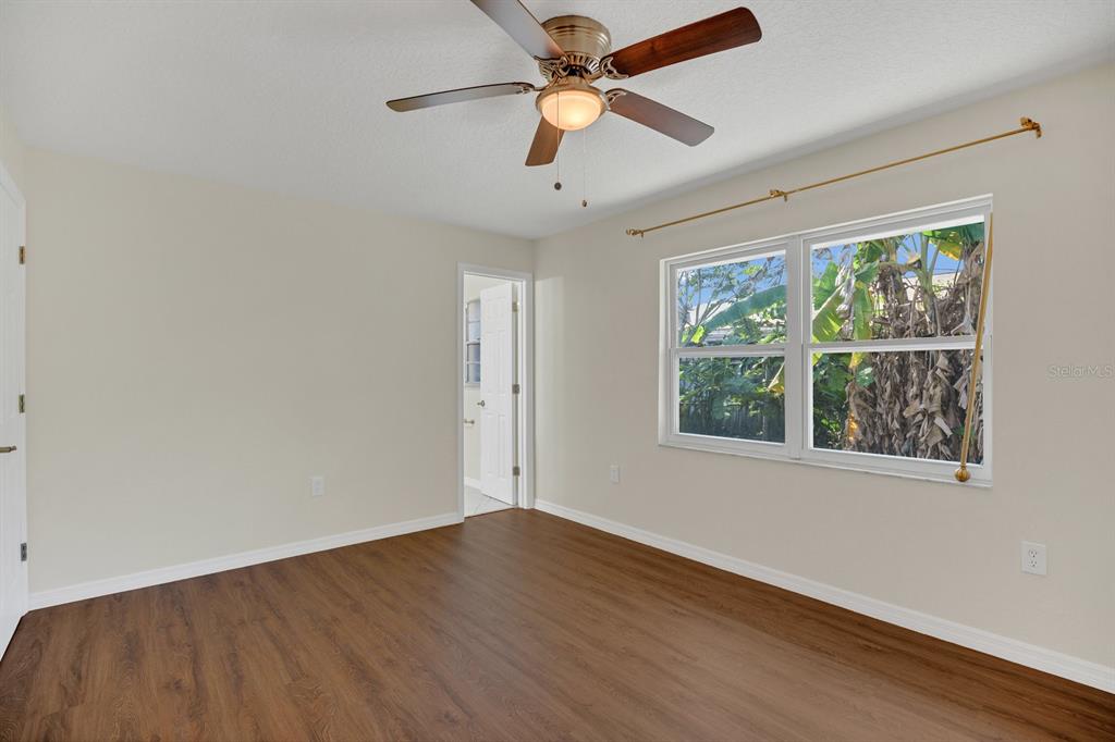 5357 Sunrise Boulevard Orlando, FL 32803 - Photo 10 of 26 wooden floor in an empty room with a window
