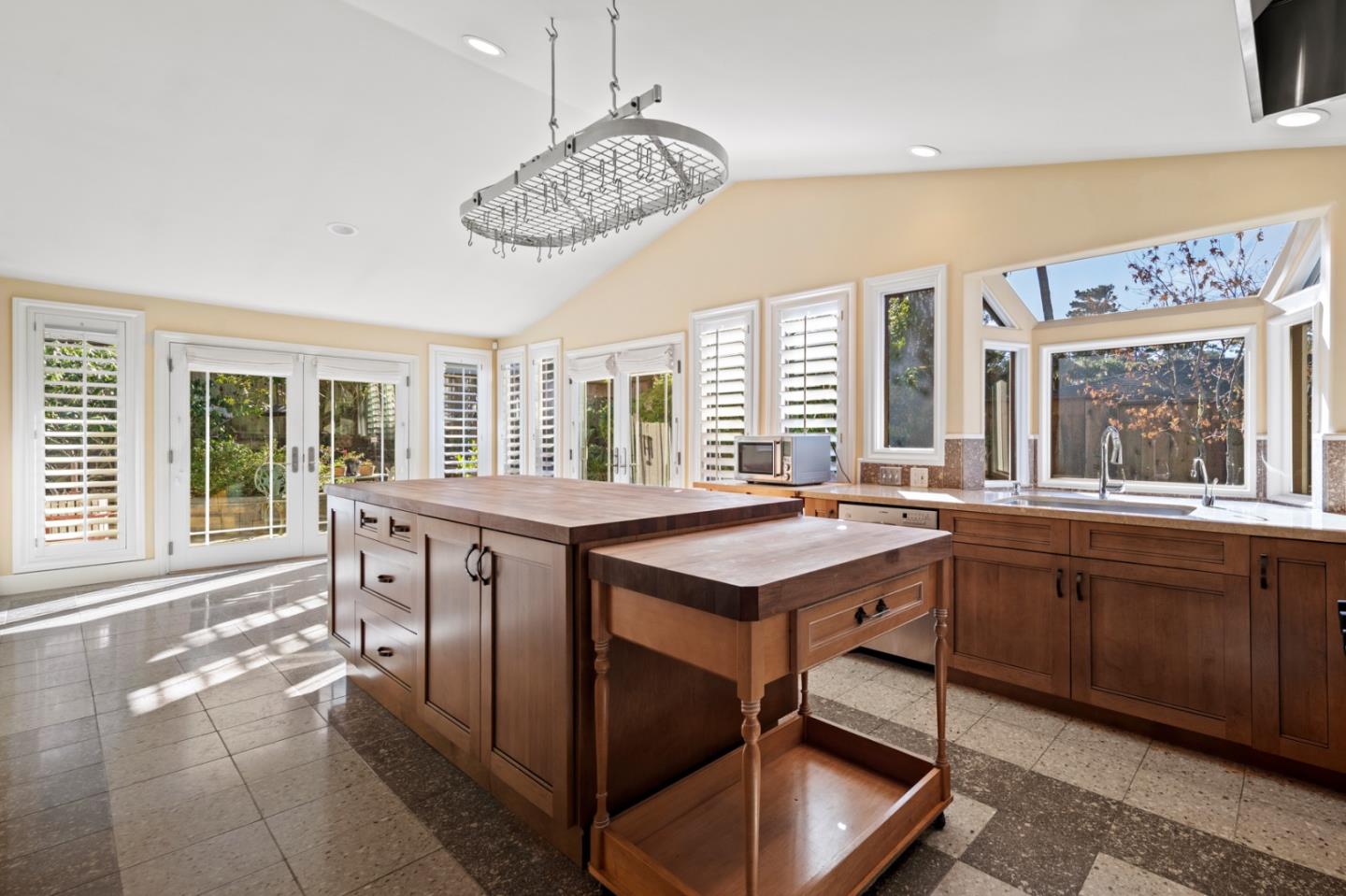 2903 Colton Road Pebble Beach, CA 93953 - Photo 11 of 32 a kitchen with a chandelier and a sink