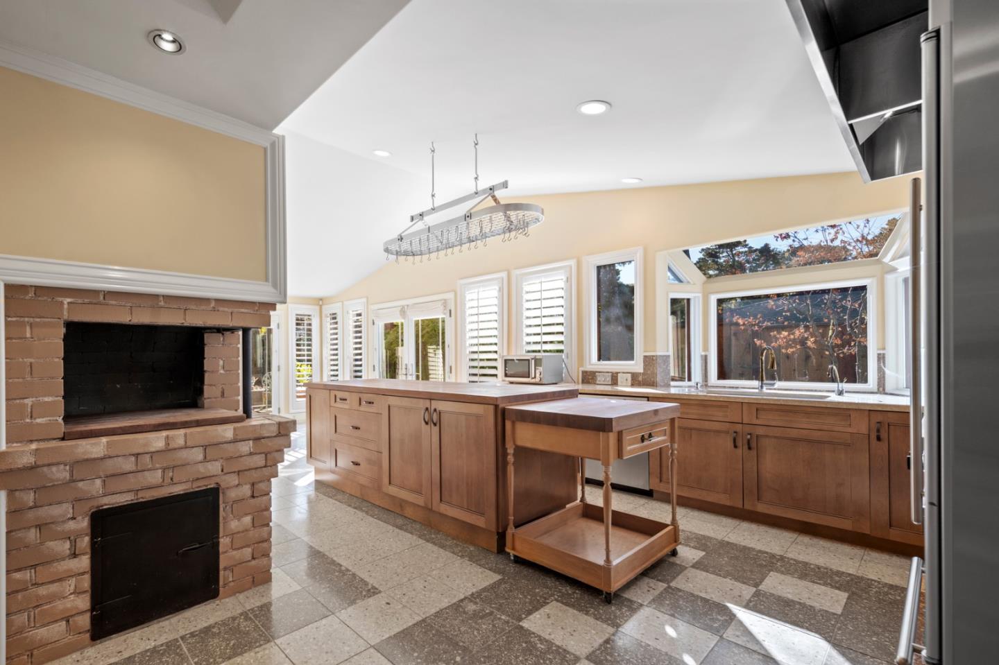 2903 Colton Road Pebble Beach, CA 93953 - Photo 13 of 32 a large kitchen with cabinets table and chairs