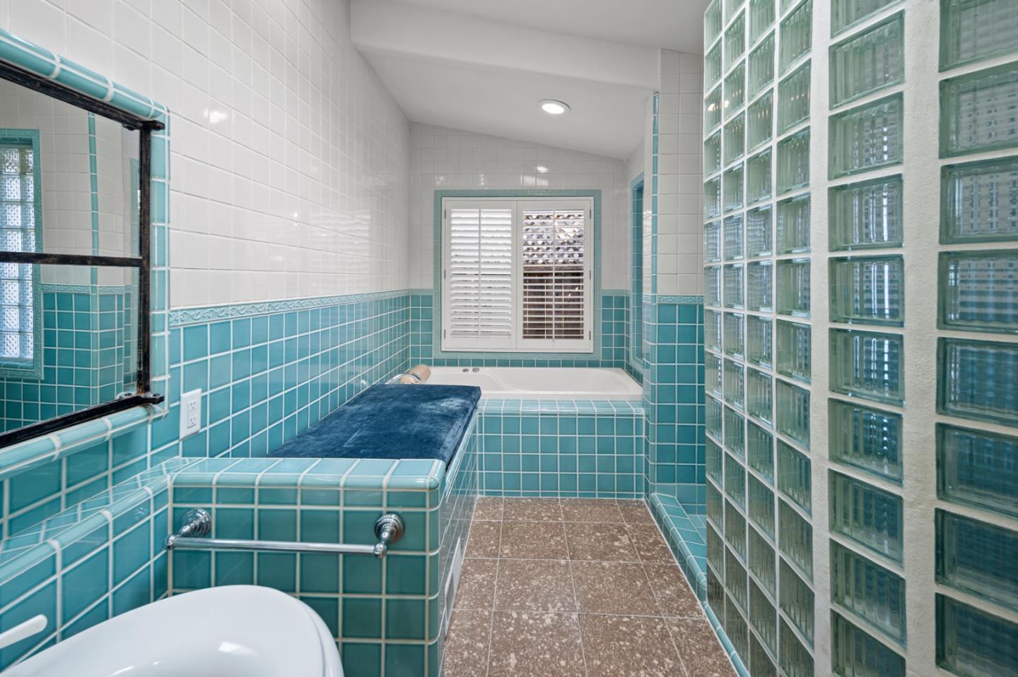 2903 Colton Road Pebble Beach, CA 93953 - Photo 19 of 32 a bathroom with a toilet a sink a shower a mirror and a bathtub