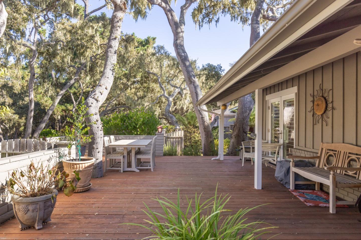 2903 Colton Road Pebble Beach, CA 93953 - Photo 28 of 32 a view of a patio with table and chairs potted plants and a large tree