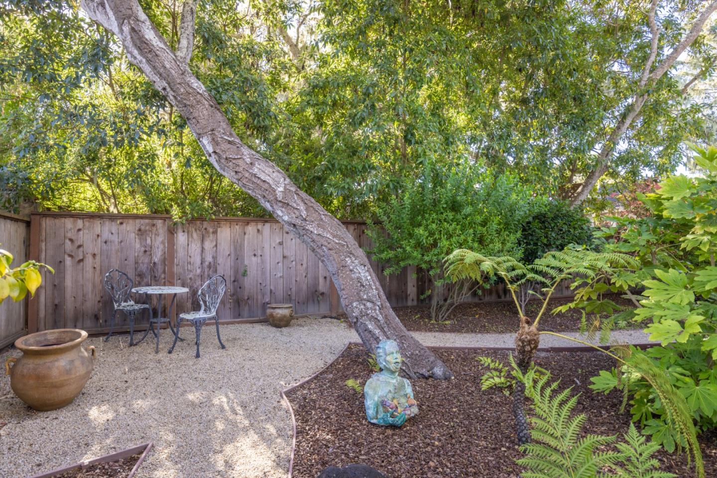 2903 Colton Road Pebble Beach, CA 93953 - Photo 30 of 32 a backyard of a house with table and chairs
