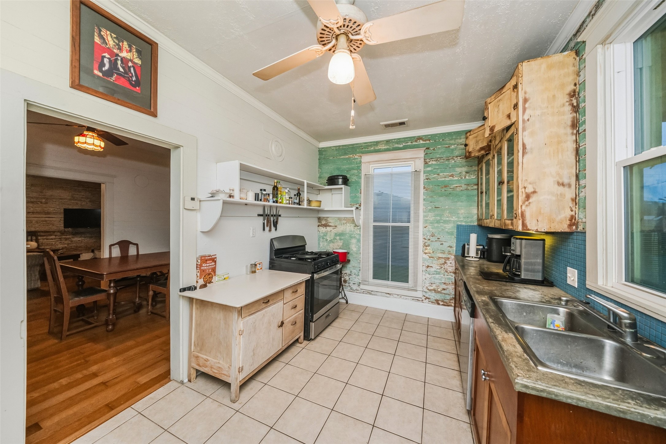 695 Wightman Street Matagorda, TX 77457 - Photo 18 of 40 a kitchen that has a sink and a stove