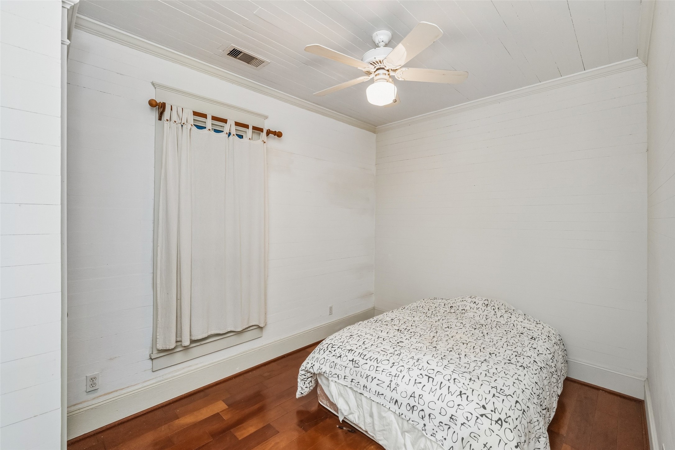 695 Wightman Street Matagorda, TX 77457 - Photo 24 of 40 an empty room with wooden floor and fan