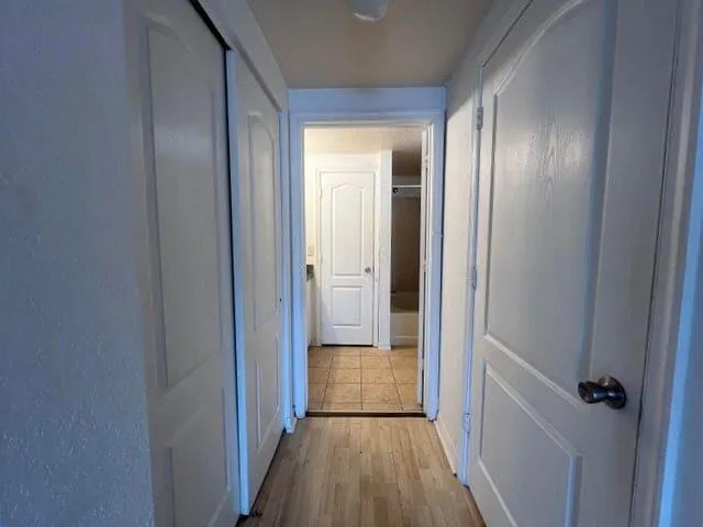 a view of a hallway with wooden floor