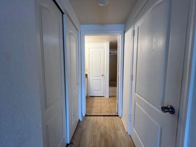 132 Southwest Peacock Boulevard, Unit 17104 Port St. Lucie, FL 34986 - Photo 14 of 28 a view of a hallway with wooden floor