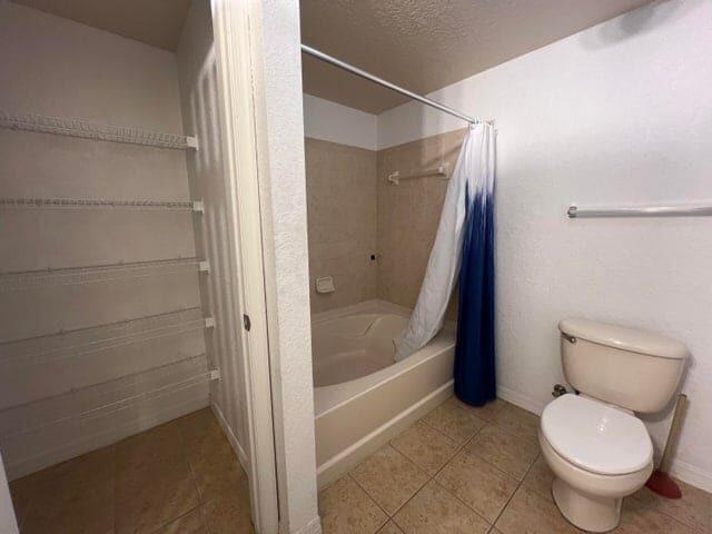 132 Southwest Peacock Boulevard, Unit 17104 Port St. Lucie, FL 34986 - Photo 16 of 28 a bathroom with a toilet and a shower