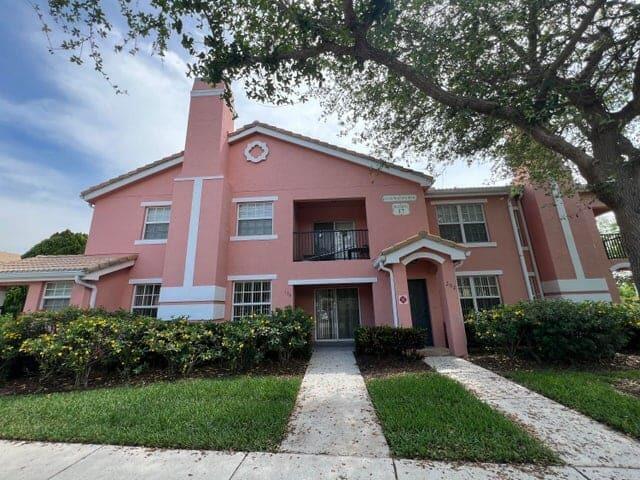 132 Southwest Peacock Boulevard, Unit 17104 Port St. Lucie, FL 34986 - Photo 18 of 28 a front view of a house with yard and green space