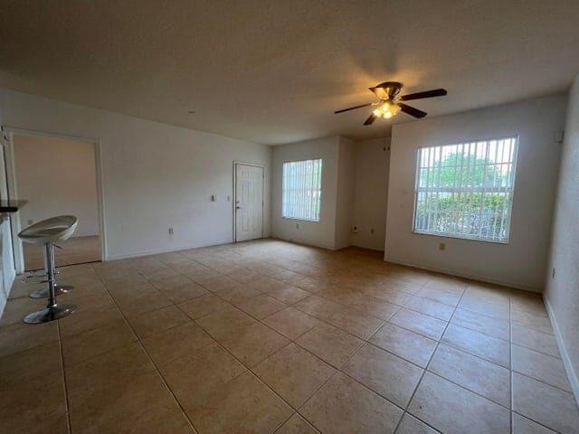 132 Southwest Peacock Boulevard, Unit 17104 Port St. Lucie, FL 34986 - Photo 2 of 28 a view of a livingroom with a ceiling fan and window