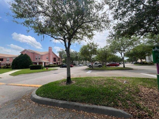 132 Southwest Peacock Boulevard, Unit 17104 Port St. Lucie, FL 34986 - Photo 27 of 28 a park with lots of trees and flowers