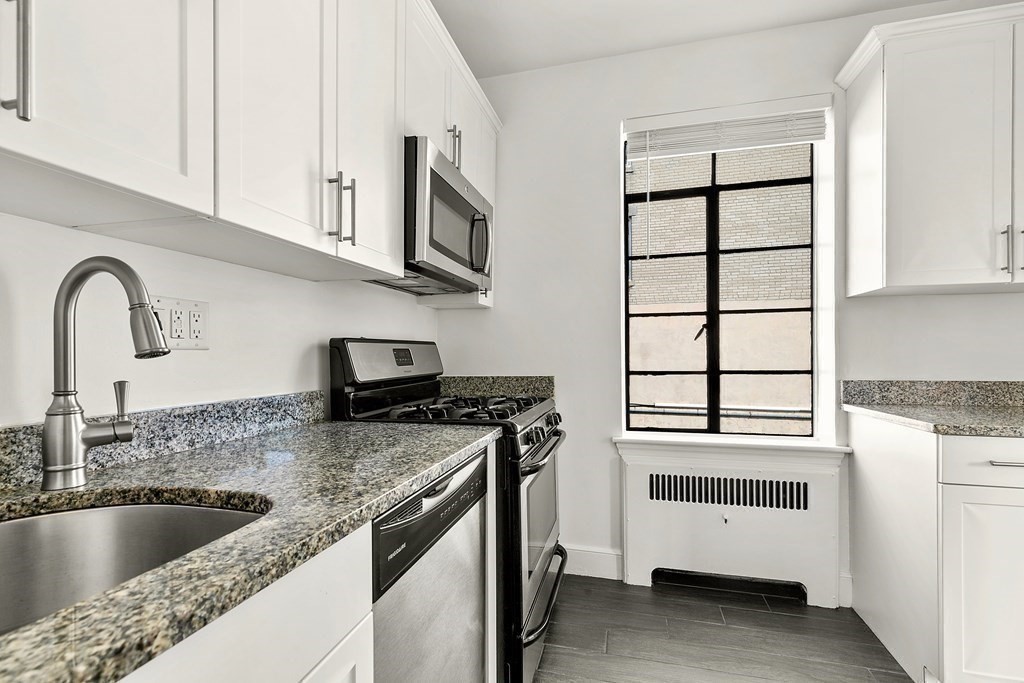 46 Chiswick Road, Unit 7 Boston, MA 02135 - Photo 6 of 16 a kitchen with granite countertop a sink and a stove top oven