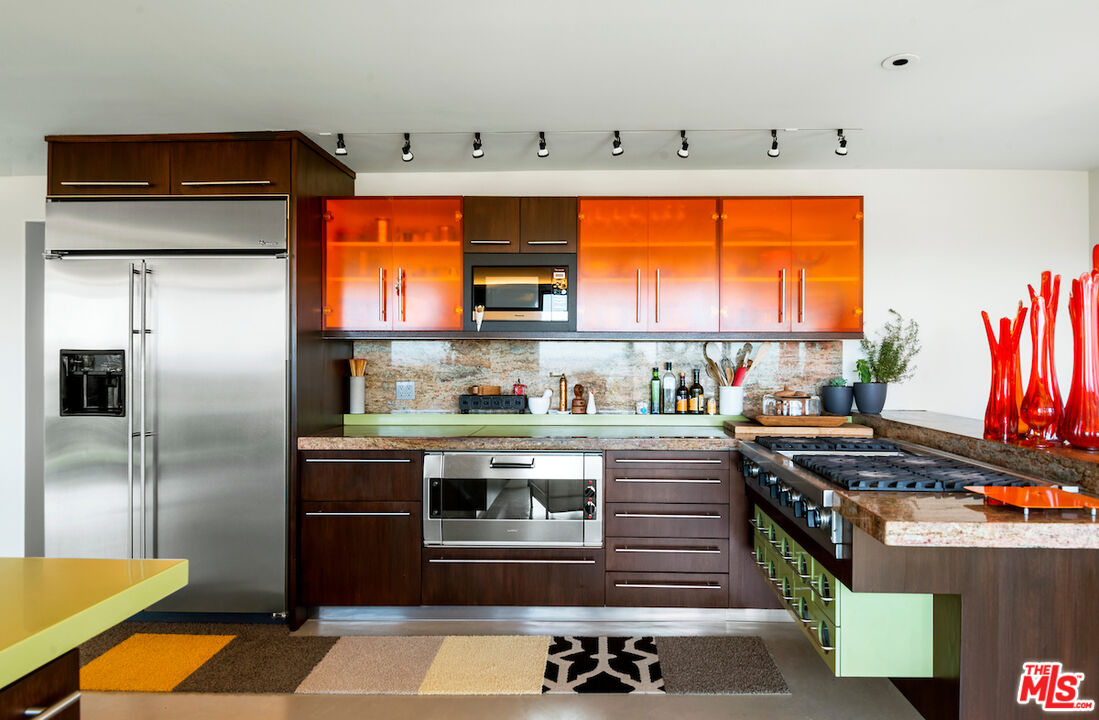 5668 Tryon Road Los Angeles, CA 90068 - Photo 12 of 21 a kitchen with stainless steel appliances granite countertop a stove and a refrigerator