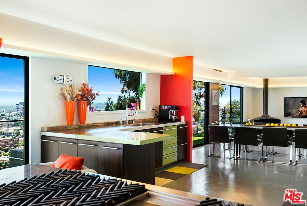 5668 Tryon Road Los Angeles, CA 90068 - Photo 13 of 21 a kitchen with stainless steel appliances granite countertop a stove and a dining table