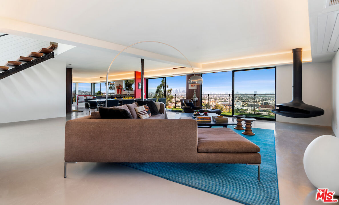 5668 Tryon Road Los Angeles, CA 90068 - Photo 7 of 21 a living room with furniture a flat screen tv and a large window
