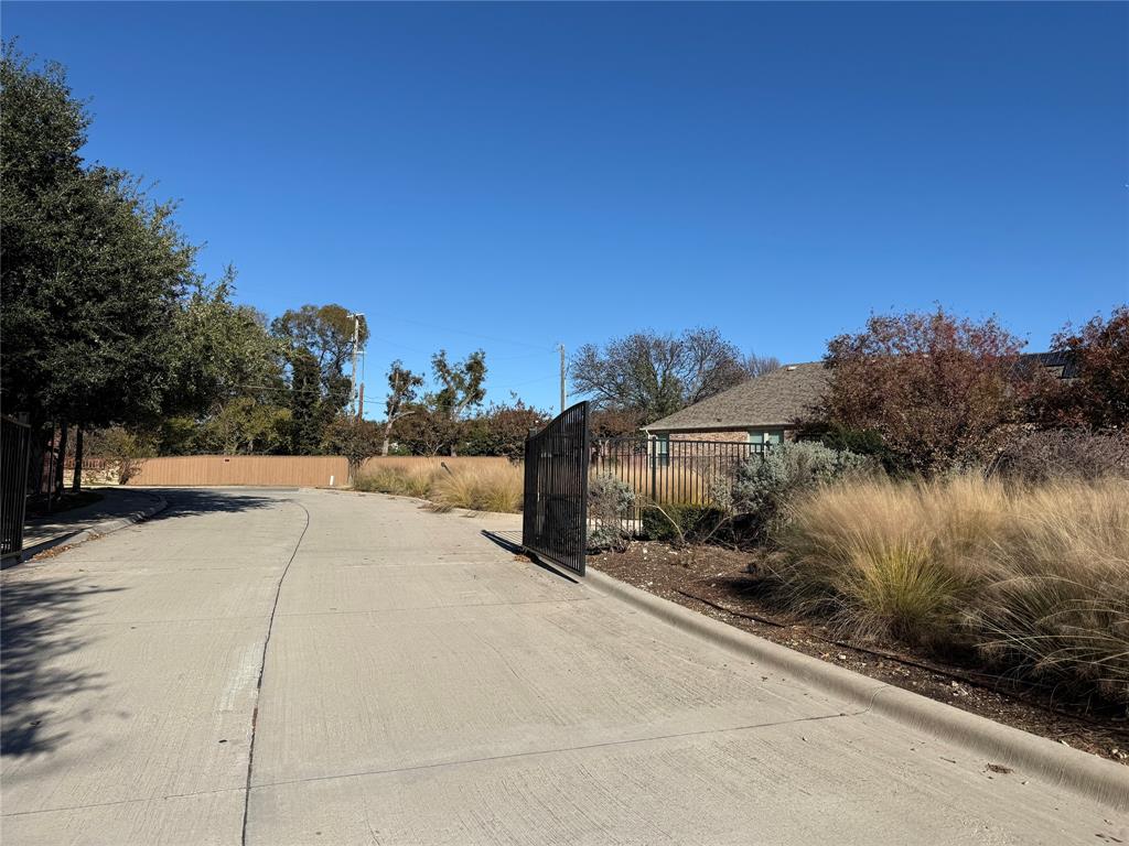 8089 Rabbit Drive Frisco, TX 75034 - Photo 11 of 37 View of road featuring curbs and a gate