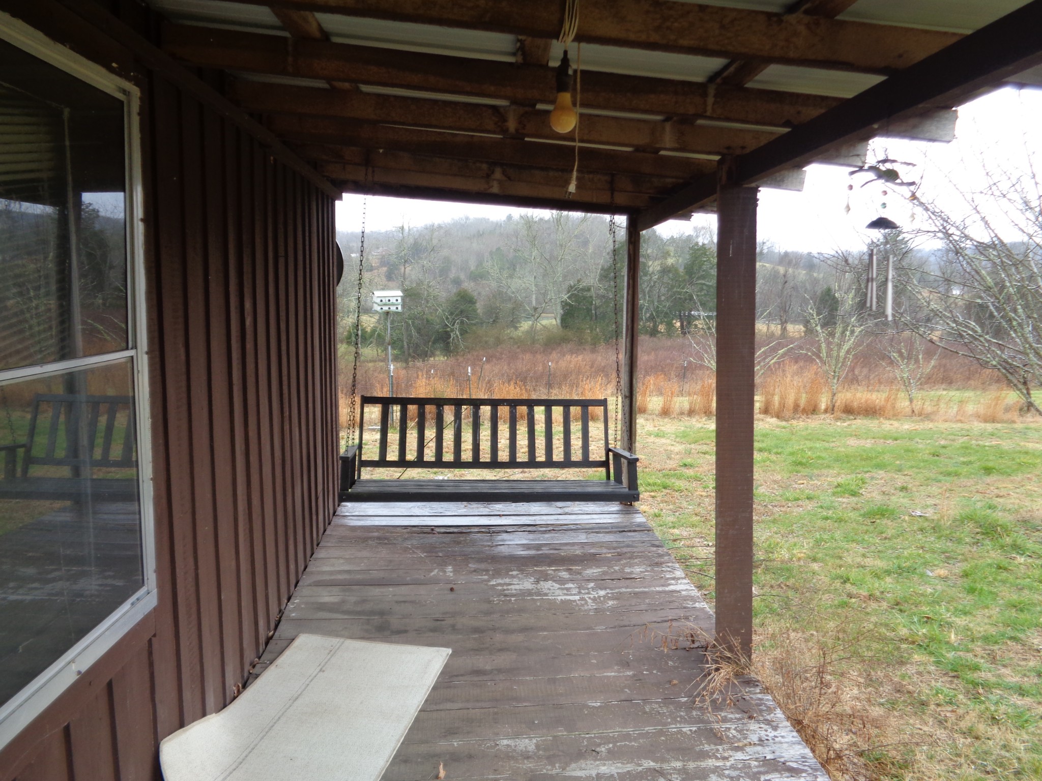 440 Stella Church Road Prospect, TN 38477 - Photo 5 of 18 a view of a porch with wooden floor and outdoor space