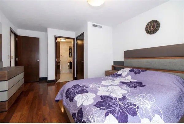 a bedroom with a bed and a couch