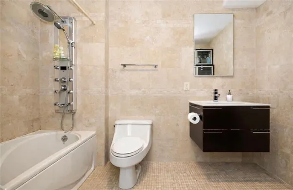 a bathroom with a toilet a sink and bathtub