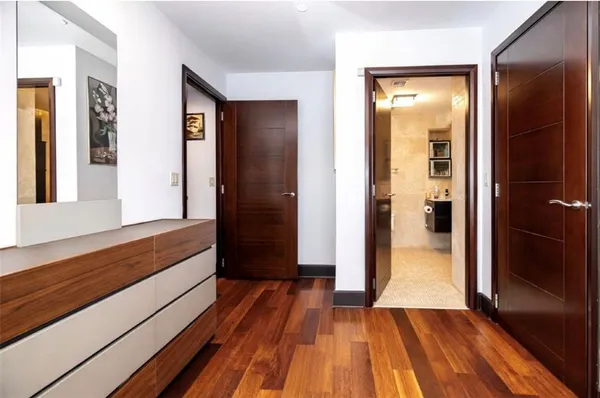 a room with gym equipment and wooden floor