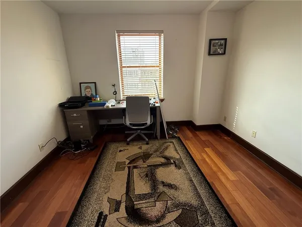 an empty room with wooden floor and closet