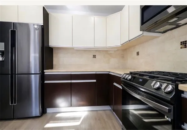 a kitchen with appliances and cabinets