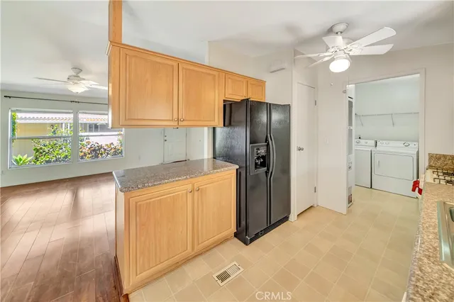 a view of a kitchen with a sink and a refrigerator