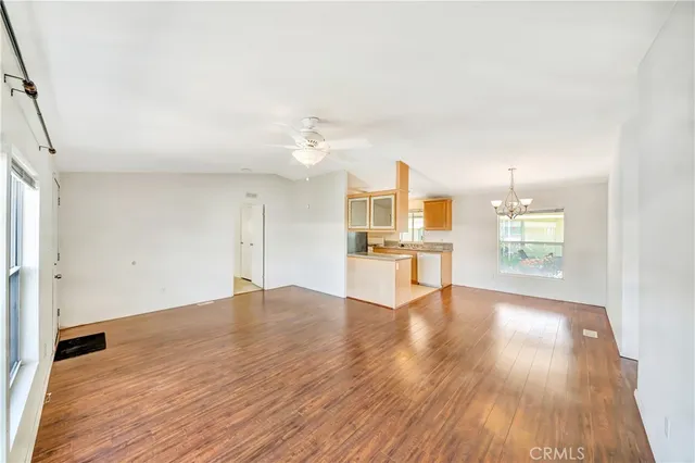 a view of a kitchen with wooden floor and a kitchen
