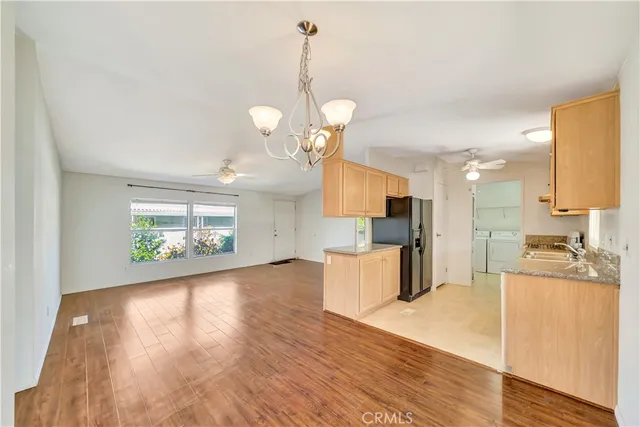 a view of a kitchen with sink microwave and cabinets