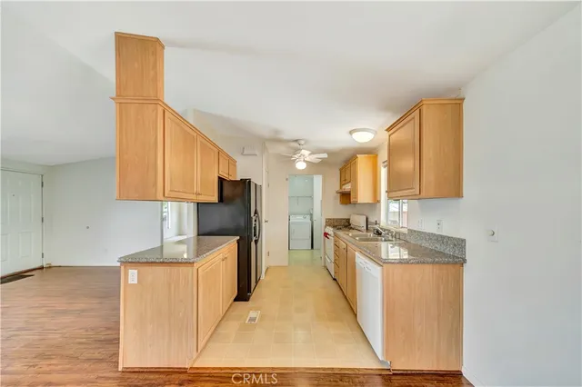 a kitchen with stainless steel appliances granite countertop a sink stove and cabinets