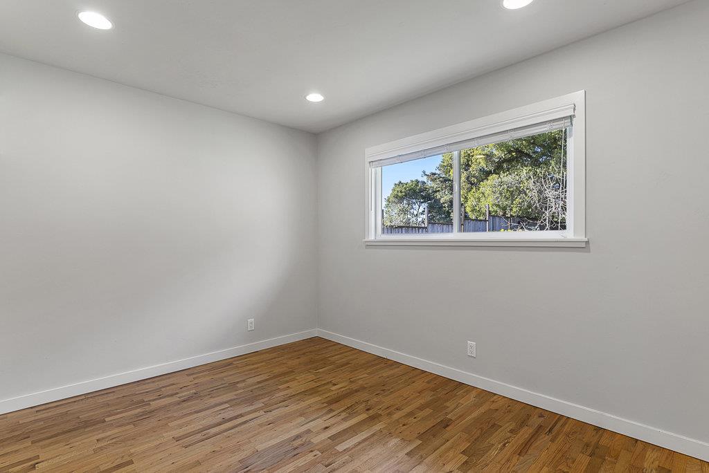 213 Siesta Drive Aptos, CA 95003 - Photo 22 of 33 an empty room with wooden floor and windows