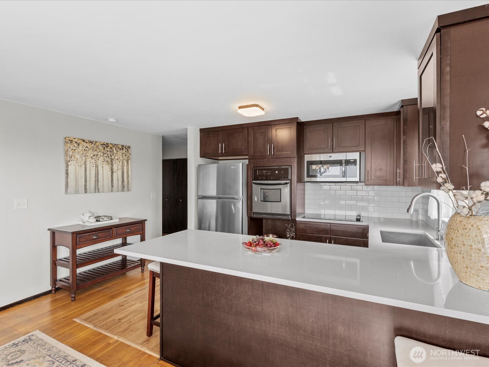 1401 Southwest 137th Street Burien, WA 98166 - Photo 16 of 40 a kitchen with stainless steel appliances kitchen island granite countertop a refrigerator and a stove top oven