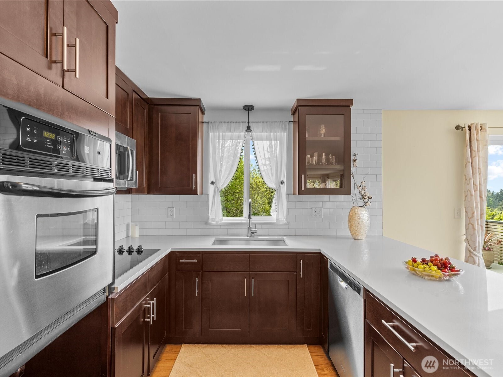 1401 Southwest 137th Street Burien, WA 98166 - Photo 17 of 40 a kitchen with kitchen island granite countertop a sink cabinets stainless steel appliances and a window