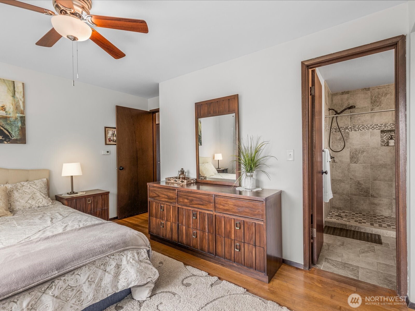 1401 Southwest 137th Street Burien, WA 98166 - Photo 21 of 40 a bedroom with a bed a mirror on the dresser and chandelier