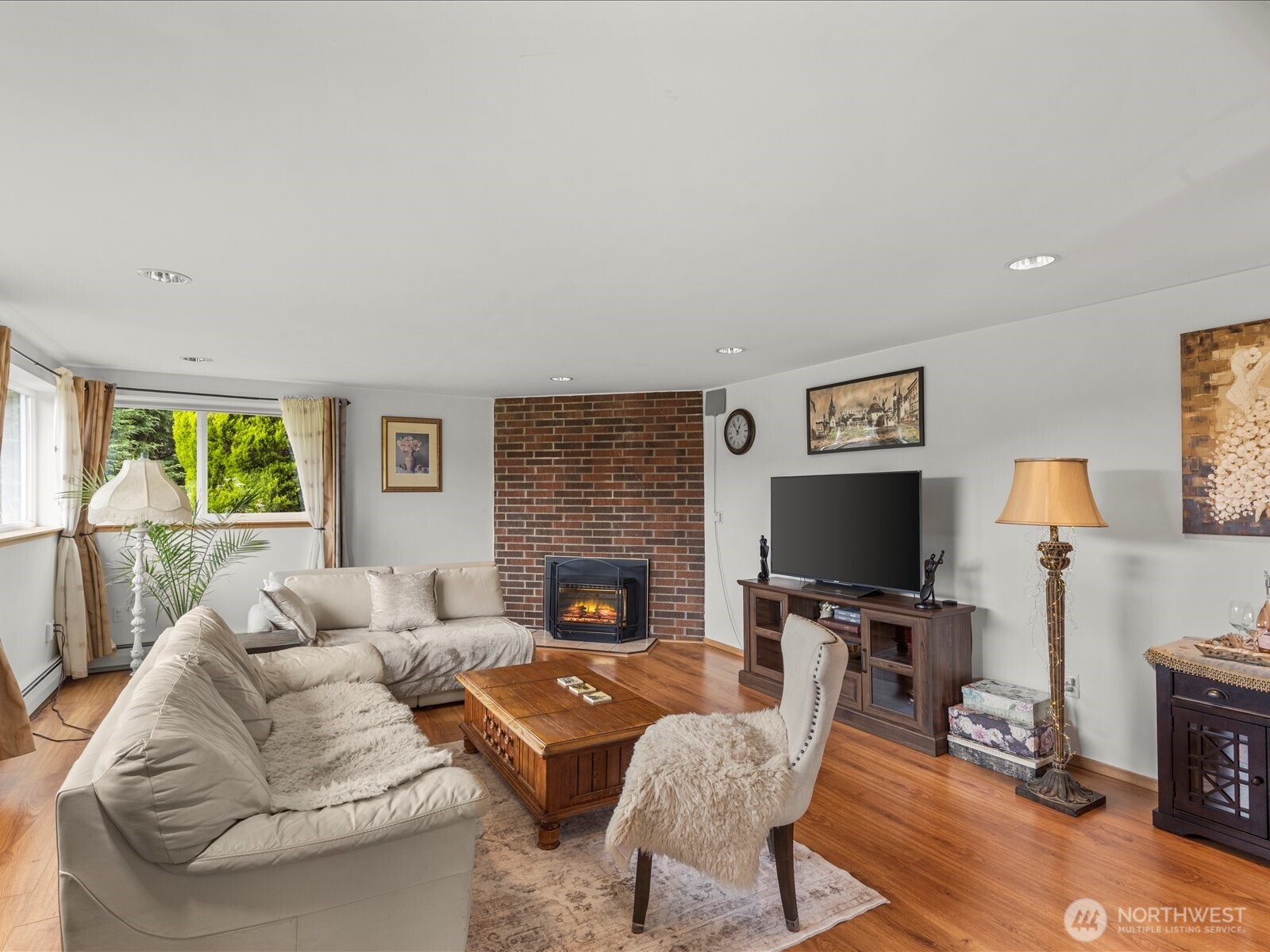 1401 Southwest 137th Street Burien, WA 98166 - Photo 31 of 40 a living room with furniture a fireplace and a flat screen tv