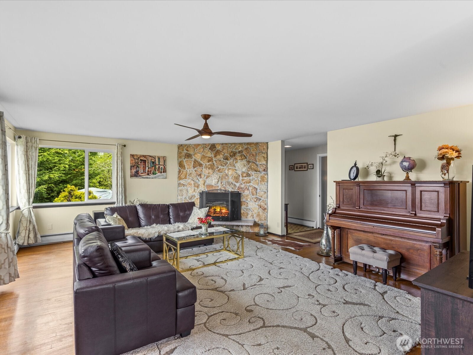 1401 Southwest 137th Street Burien, WA 98166 - Photo 9 of 40 a living room with furniture a fireplace and a large window