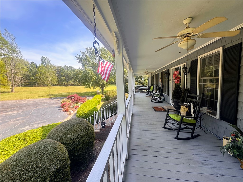 208 Knoxwood Court Anderson, SC 29621 - Photo 12 of 38 Relax on the expansive covered porch overlooking lush green landscapes.