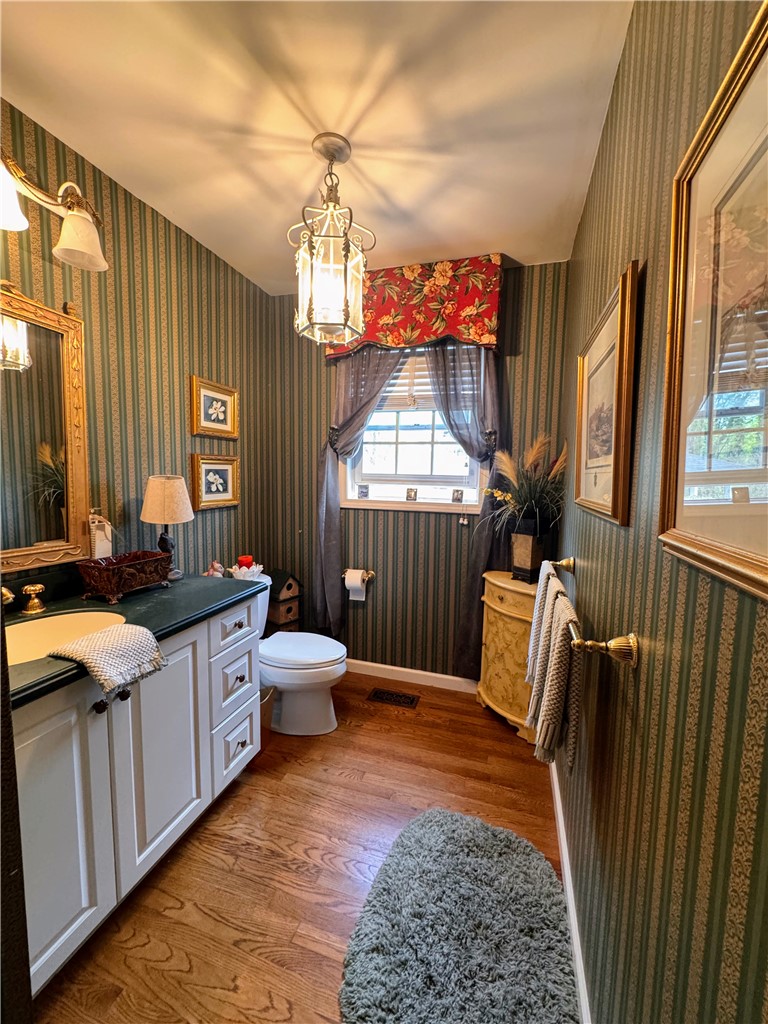208 Knoxwood Court Anderson, SC 29621 - Photo 25 of 38 This inviting bathroom features elegant hardwood flooring and a functional vanity with a built-in sink.