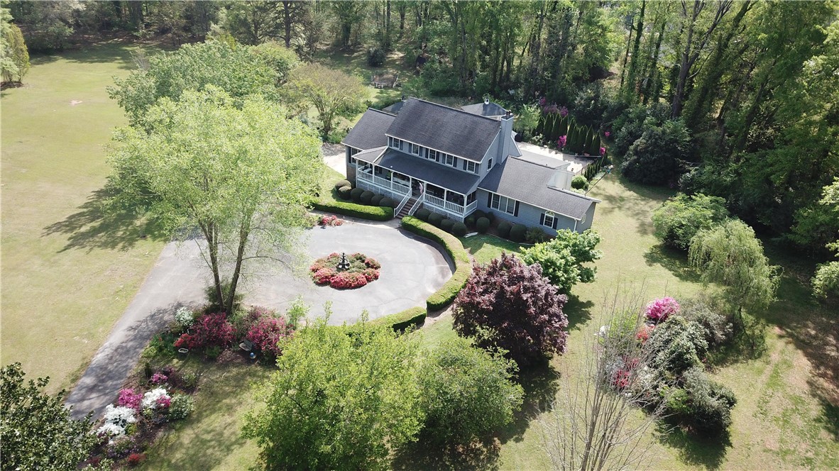 208 Knoxwood Court Anderson, SC 29621 - Photo 26 of 38 This grand residence is nestled amidst lush greenery, featuring an expansive driveway and mature landscaping.
