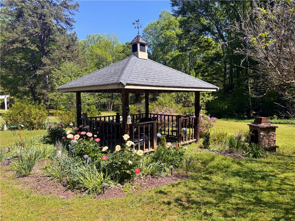 208 Knoxwood Court Anderson, SC 29621 - Photo 30 of 38 This outdoor gazebo is surrounded by vibrant blooms, perfect for enjoying peaceful moments.