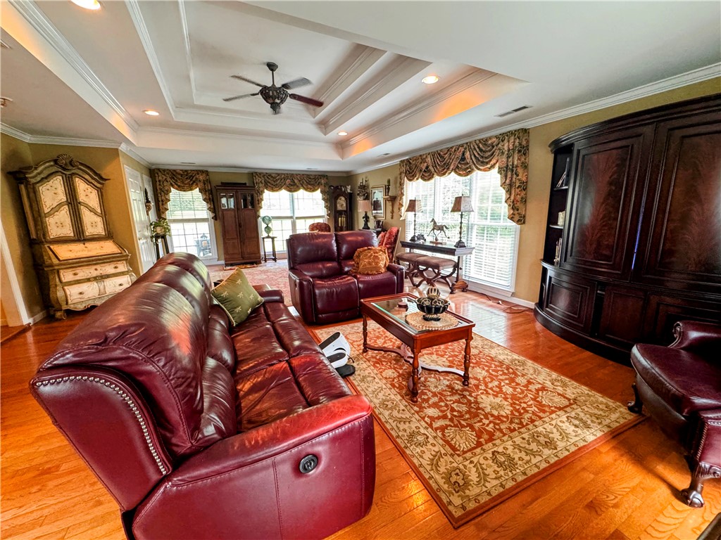 208 Knoxwood Court Anderson, SC 29621 - Photo 38 of 38 This living room features a tray ceiling with recessed lighting, creating an inviting and refined atmosphere.