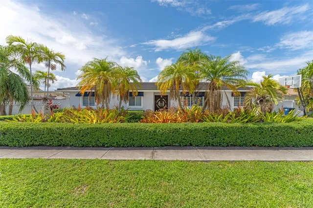 a view of a house with a swimming pool and a yard