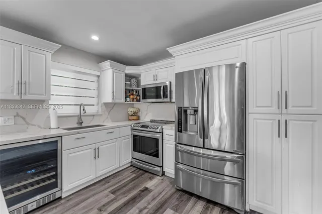 a kitchen with a refrigerator stove and sink