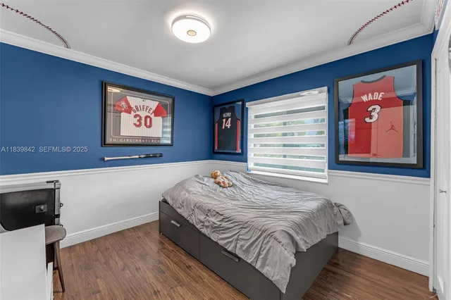 a bedroom with a bed and a wall painting