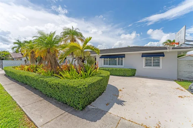a front view of a house with a garden
