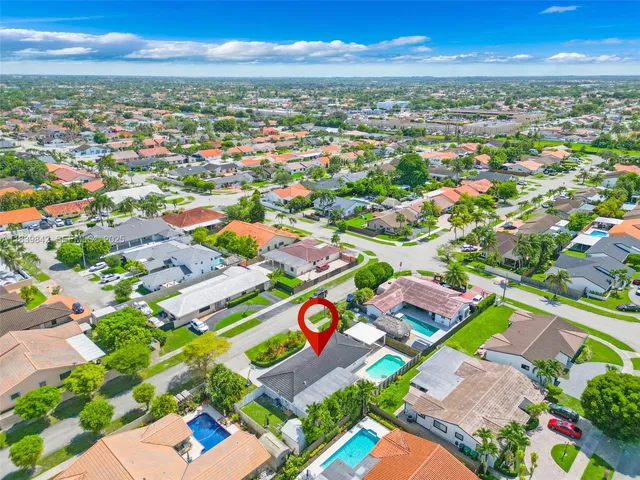 an aerial view of residential houses with outdoor space