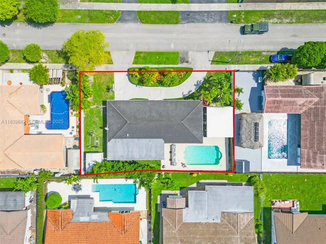 an aerial view of a house with a yard and lake view